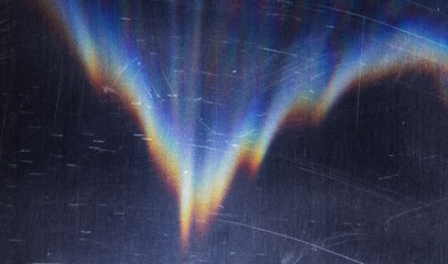 Blur colorful warm pink rainbow light leaks on black background. Defocused abstract analog retro...