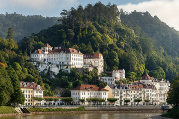 Obraz premium serene view of ancient european castle surrounded by lush greenery and clear skies