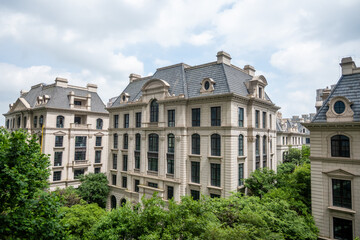 Obraz premium European-style buildings stand in Shanghai, reflecting colonial influences. These structures, a legacy of the treaty port era, blend with modern greenery.