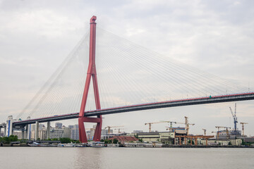 Yangpu Bridge, a cable-stayed bridge in Shanghai, China, stretches across the Huangpu River. Completed in 1993, it marked a new era for infrastructure development in the city.