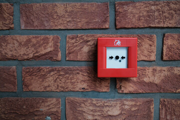 Red fire alarm switch on a brick wall Safety equipment for emergency Protection and prevention from fire in a building