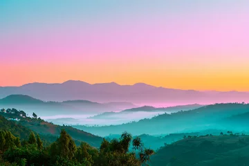 Fototapeten tranquil sunrise with pastel pink and teal morning haze © Luluraschi