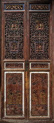 Elaborate wood carvings and lattices ornate the door, showcasing traditional craftsmanship in Hongcun Village, Anhui Province near Mount Huangshan, China