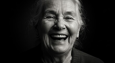 Black and white expressive portrait captures the unreserved joy of an elderly woman