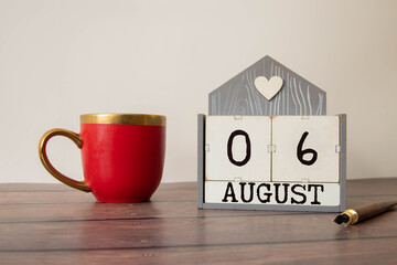 Wooden block calendar with the date August 06