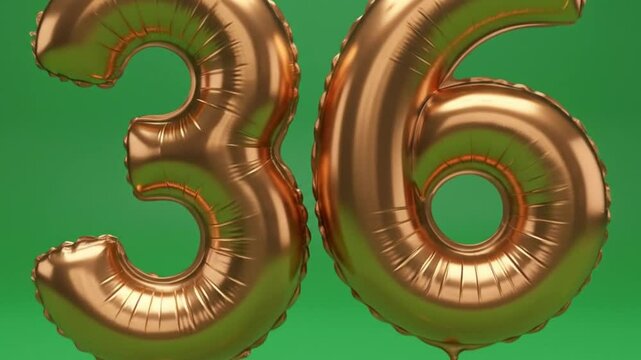Golden number 36 balloons floating with falling confetti on green screen background celebration