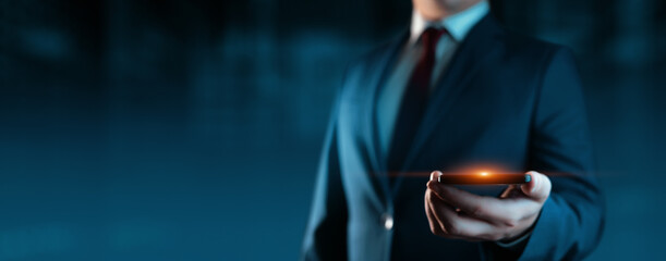 A businessman holds a smartphone. Business Technology Concept