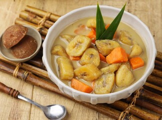Kolak Pisang is an Indonesian dessert made from bananas, pumpkin cooked with coconut milk, palm sugar and pandan leaves.