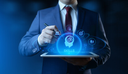 Businessman holding tablet with Skills icons on screen - Education and E-Learning Concept