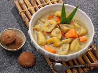 Kolak Pisang is an Indonesian dessert made from bananas, pumpkin cooked with coconut milk, palm sugar and pandan leaves.