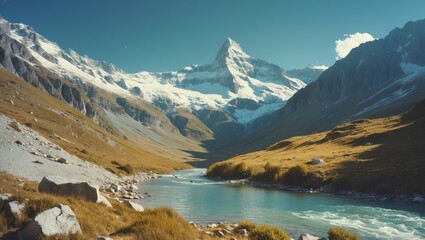 Obraz premium Mountain landscape with river flowing through the valley and snow-capped peaks in the background.