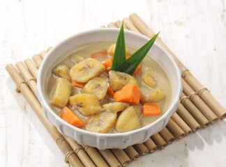 Kolak Pisang is an Indonesian dessert made from bananas, pumpkin cooked with coconut milk, palm sugar and pandan leaves.