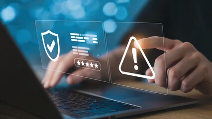 Cyber security protection shield and warning alert on a laptop
