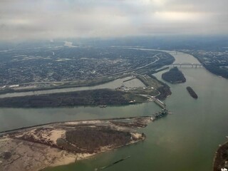 Aerial view of river confluence at Louisville, Kentucky, and Clarksville, Indiana. Bridges, urban...