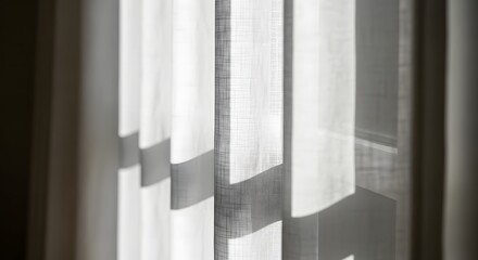 Sunlight streams through sheer white curtains, casting delicate shadows on the fabric.