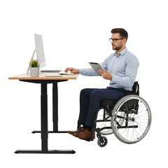 Professional man using computer in wheelchair at modern office