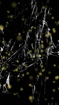 Animation of yellow particles floating over light on moving shiny black plastic