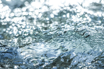 The shimmering dance of light and shadow on the clear water surface
