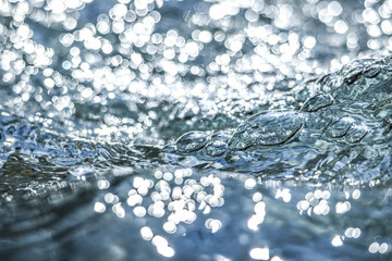 The shimmering dance of light and shadow on the clear water surface