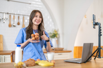 Woman nutritionist healthy food content creator live streaming with breakfast, milk, banana, bread...