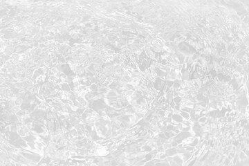 White water with ripples on the surface. Defocus blurred transparent white colored clear calm water surface texture with splashes and bubbles. Water waves with shining pattern texture background.