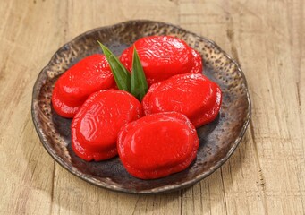 Kueku or Angku Kueh. Ku cake or tok cake or red turtle cake is a traditional small round or oval cake wrapped in a skin made from sticky and soft sticky rice with a sweet filling in the middle