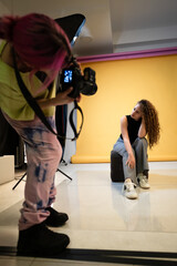 Photographer Capturing a Model Posing in a Studio With Bright Background
