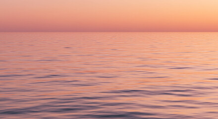 Fototapeta premium Soft ocean ripples in a pastel pink-orange gradient at sunrise