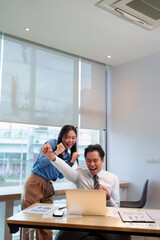 Asian adult professional team celebrating business success online finance achievement modern office workspace digital victory collaboration