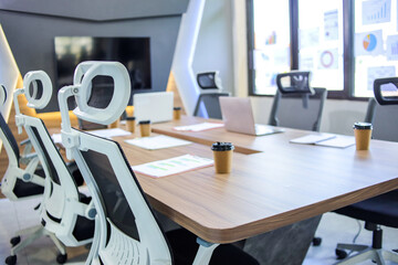Laptops and graphs Kept on Conference Table in Empty Meeting Room
