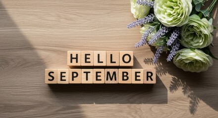 Hello September Wooden Blocks with Flowers on Wood Background Top View.