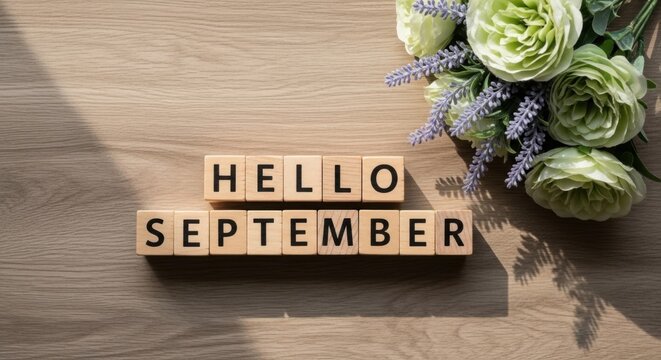Hello September Wooden Blocks with Flowers on Wood Background Top View.