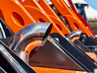 Heavy machinery exhaust pipes displayed at a construction equipment exhibition in a sunny outdoor...