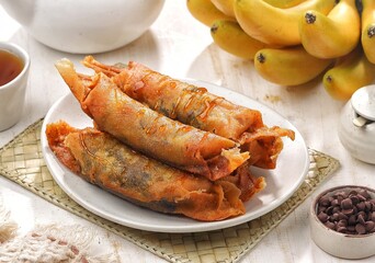 Piscok, Pisang Coklat Karamel. Caramel Chocolate banana is snack made from bananas. Banana Caramel itself is made from a combination of banana with chocolate jam coated in spring roll skin 