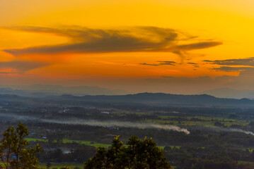 Sunset mountain range beautiful landscape mist foggy sunrise beam. Golden sky Mountain landscape foggy windy mountain. Amazing Landscape cloud sky on sunrise. Countryside gold sunlight heaven scene