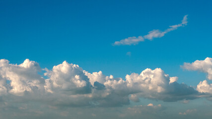 Blue sky fluffy white clouds on summer season bright clear skyline with beautiful cloudscape. Panorama blue sky clouds pattern on daylight with copy space. Cumulus cloudscape air climate sunny day