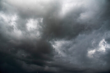 Dramatic dark storm thundercloud rain clouds on black sky background. Dark thunderstorm clouds rainny landscape. Meteorology danger windstorm disaster climate. Dark cloudscape storm disaster gray sky