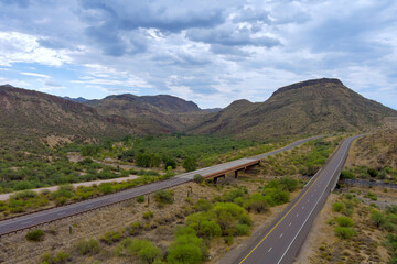 Highway intersection in desert landscape of Sunflower, Arizona roads with dramatic mountains rise...