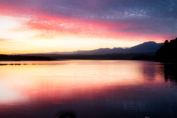 The rain forest of the West coast with the Southern Alps in the background (taken at Okarito lagoon) at sunrise