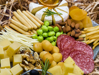 Delightful spread of gourmet cheeses, charcuterie, and tasty accompaniments for a festive gathering...