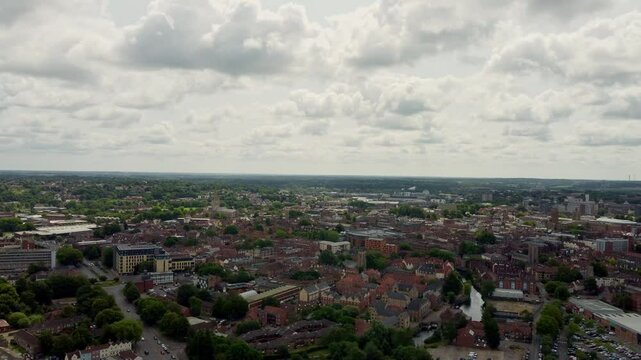 Aerial video over the City of Norwich, Norfolk. The drone moves slowly forward with a 50-50 framed shot of City and the sky. Shows the skyline captured on a cloudy day.
