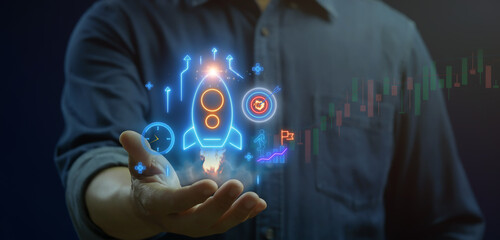 Prospective start-up concept, a new business idea or venture that is in the planning or early development stages, but not yet fully operational. Businessman shows start-up icon on virtual screen.