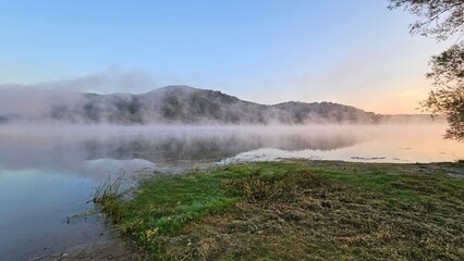 lake in the mountains covered in fog