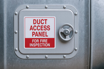 Duct access panel with metal handle for fire inspection in air system used in engineering and industry for safety and maintenance purposes