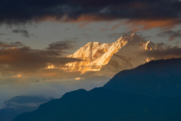 Beautiful last light from sunset on Mount Kanchenjugha, Himalayan mountain range, Sikkim, India. color tint on the mountains at dusk