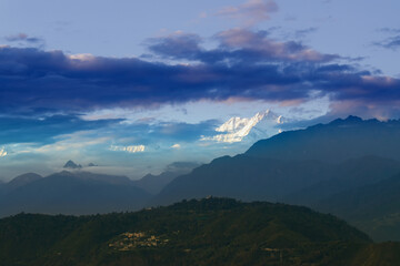 Beautiful last light from sunset on Mount Kanchenjugha, Himalayan mountain range, Sikkim, India. color tint on the mountains at dusk