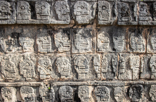 Stone Carved Skull Wall at Tzompantli Platform, Chichen Itza Maya Archaeological Site, Mexico. Old civilization pattern.