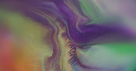 Color mix. Shiny texture. Defocused purple green yellow paint splash shimmering particles spreading...