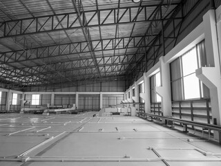Scene of interior buildings, steel and cement structure with air ventilation system on warehouse storage ceiling, under roof, with sunlight from windows. industrial factory construction concept.