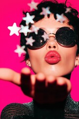 Young woman blowing glitter stars celebrating new year's eve